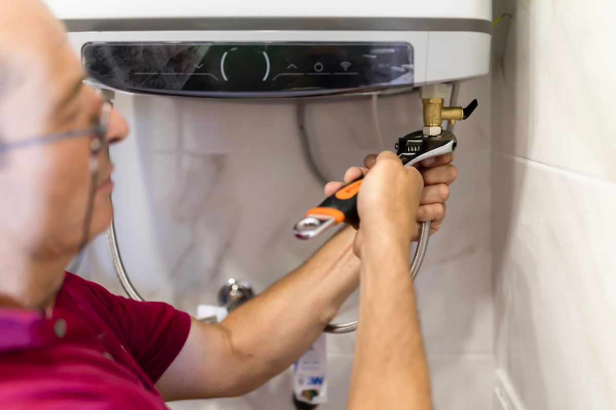 Plumber installing flexible water supply pipes