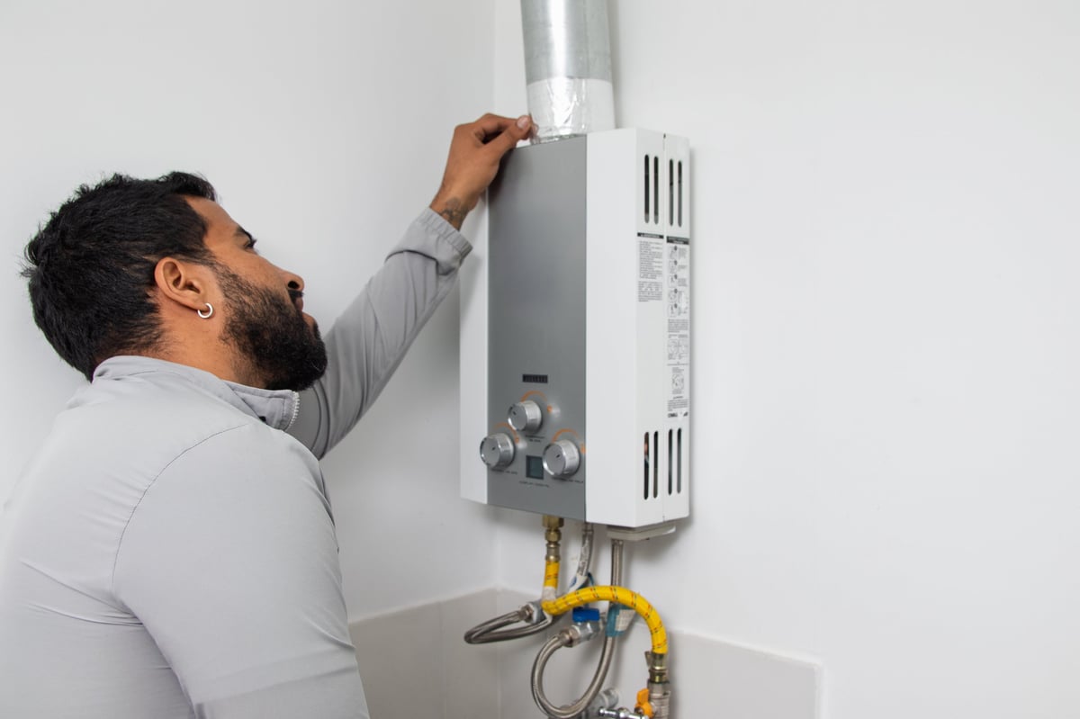 Duncan inspecting boiler venting pipe